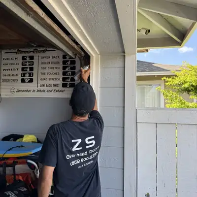 ZS Overhead Doors technician working on a garage door
