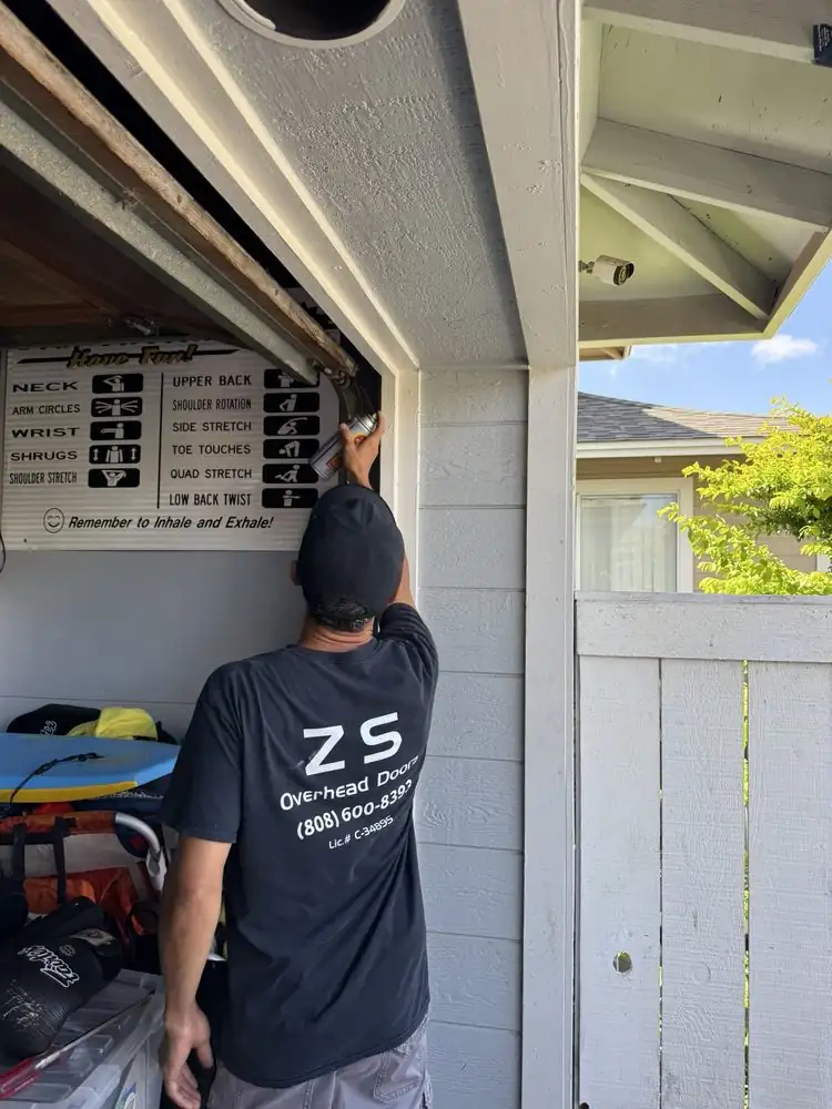 ZS Overhead Doors technician working on a garage door