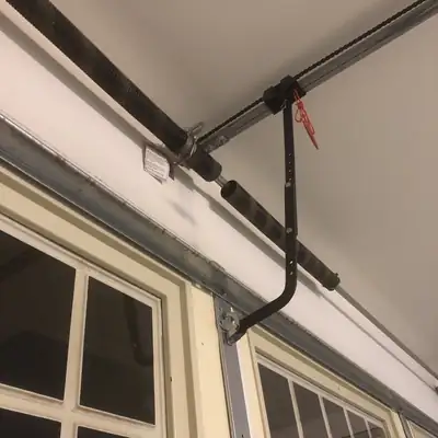 Torsion spring and track above garage windows