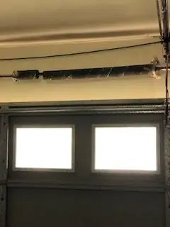 Torsion spring above garage windows